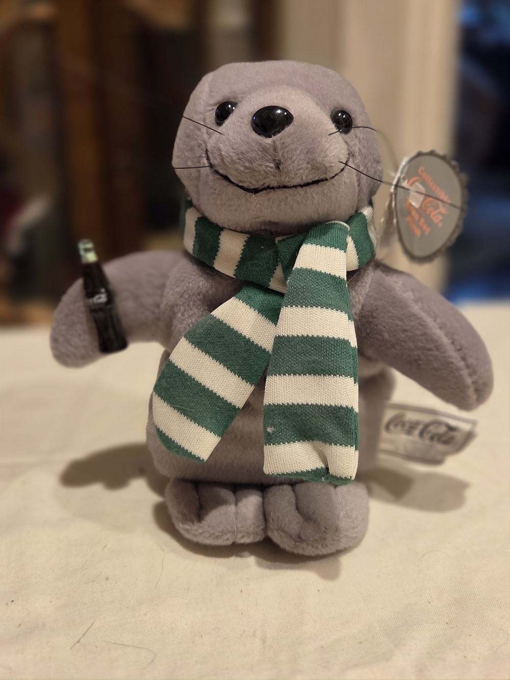 Coca Cola Gray Seal Plush with Green and White Striped Scarf